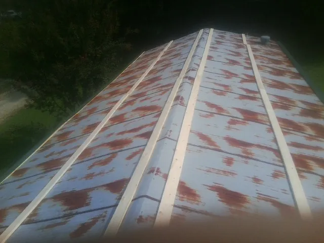 Rusted metal roof panels with new wood purlins before replacement — Storm Damage Roof Repair in Bedminster by Roofing Brothers