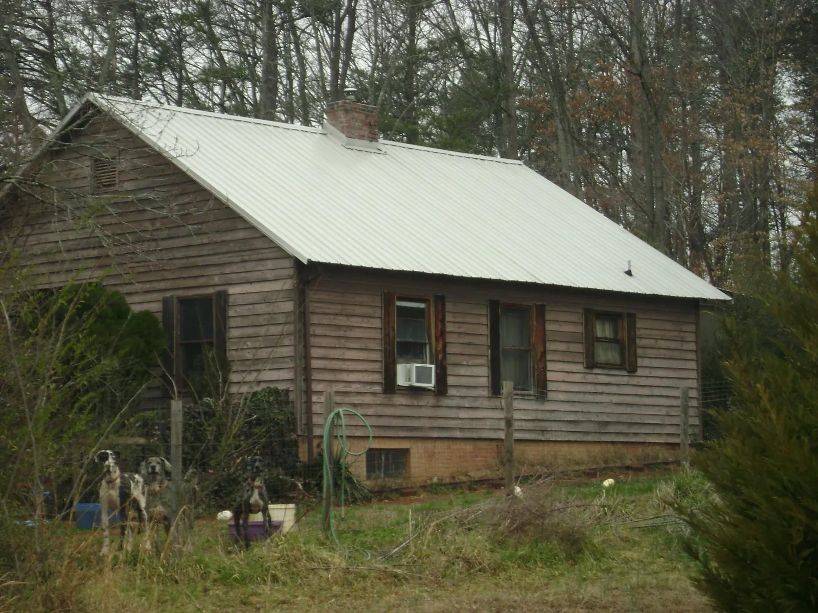 White metal roof on an old wood sided farmhouse, from a Metal Roof Installation job in Bedminster